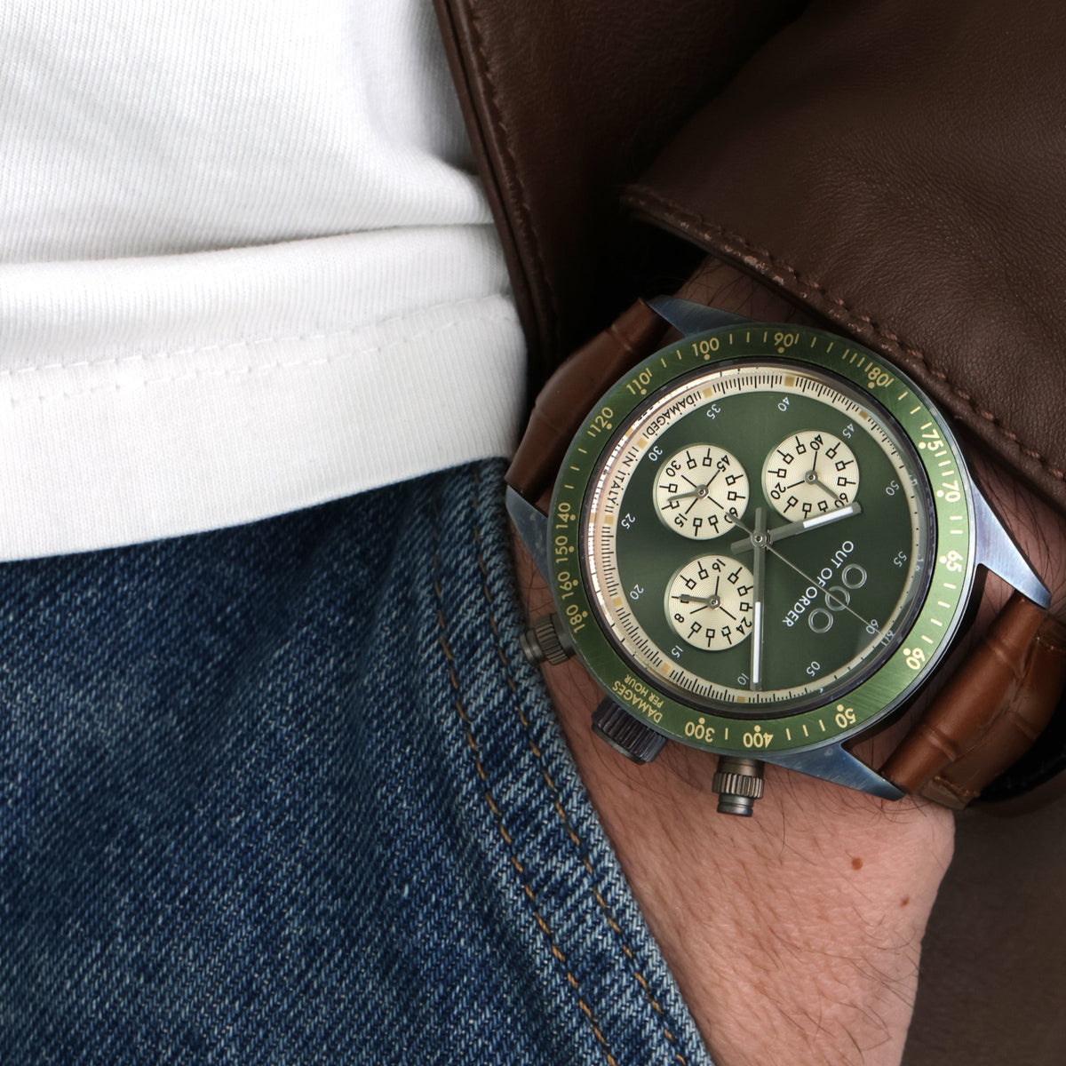 Orologio cronografo su polso, quadrante verde e cinturino in pelle marrone.