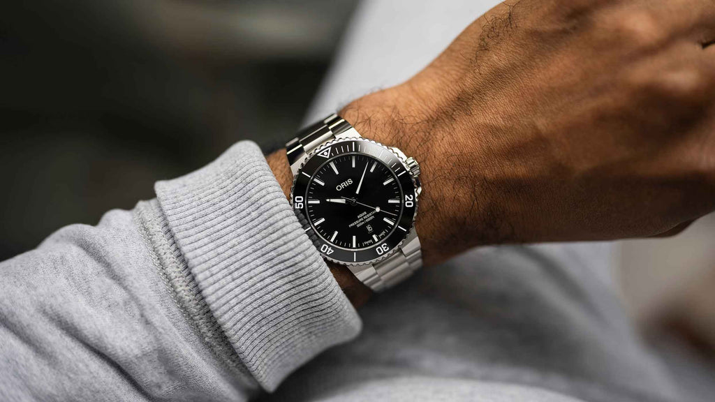 Orologio sub acciaio con quadrante nero, bracciale maglia e ghiera girevole