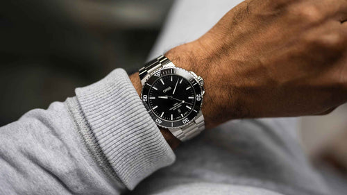Orologio sub acciaio con quadrante nero, bracciale maglia e ghiera girevole
