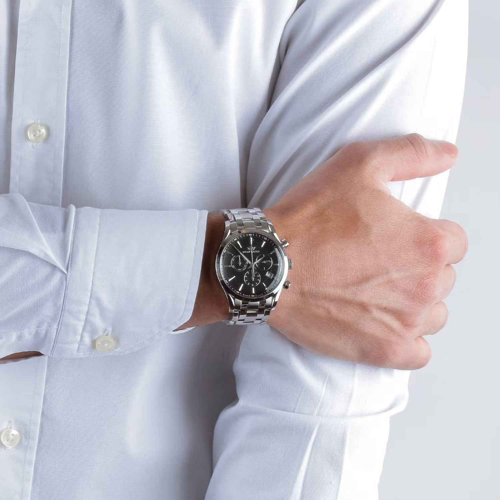 Orologio cronografo in acciaio al polso con quadrante nero e bracciale a maglie