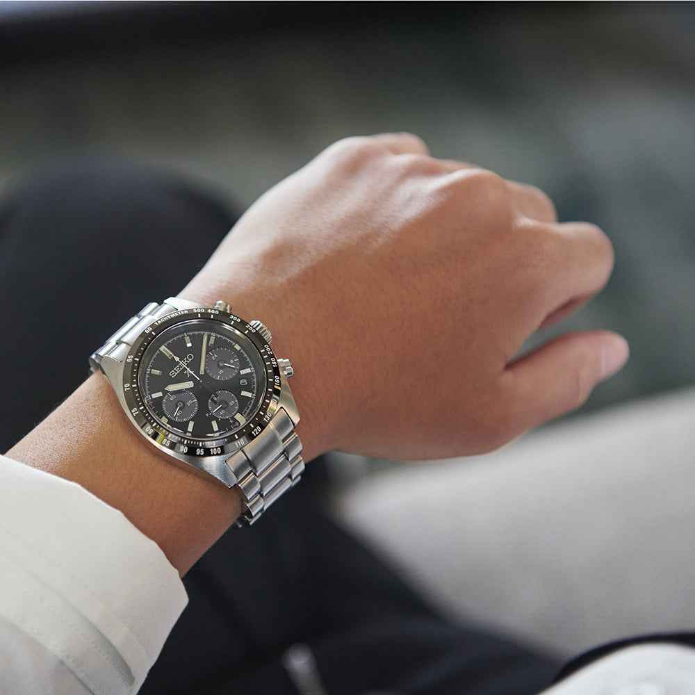 Orologio cronografo solare con quadrante nero e bracciale in acciaio, vista laterale