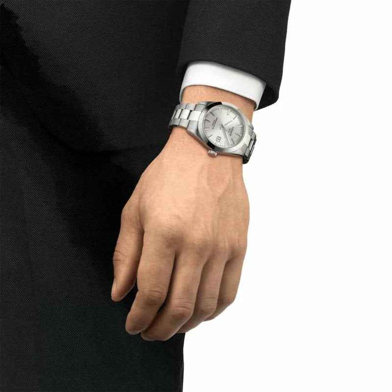 Orologio Tissot con quadrante argento e bracciale acciaio, sul polso con manica scura
