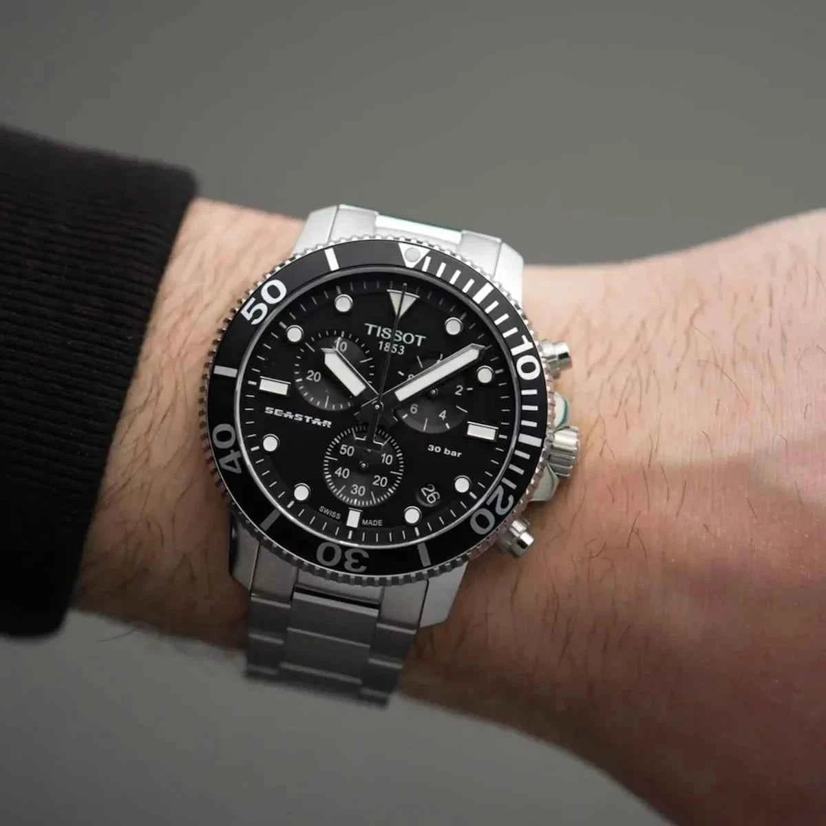Orologio subacqueo Tissot con quadrante nero e cinturino in acciaio sul polso