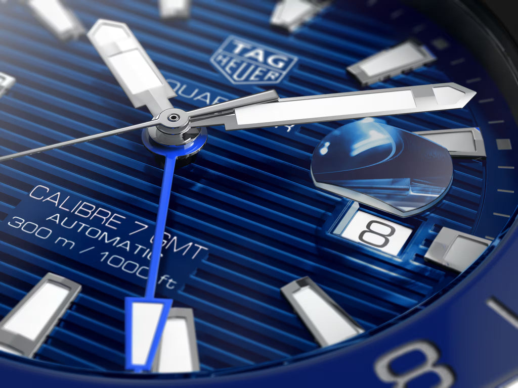 Primo piano quadrante blu con indici bianchi, lancette GMT e datario