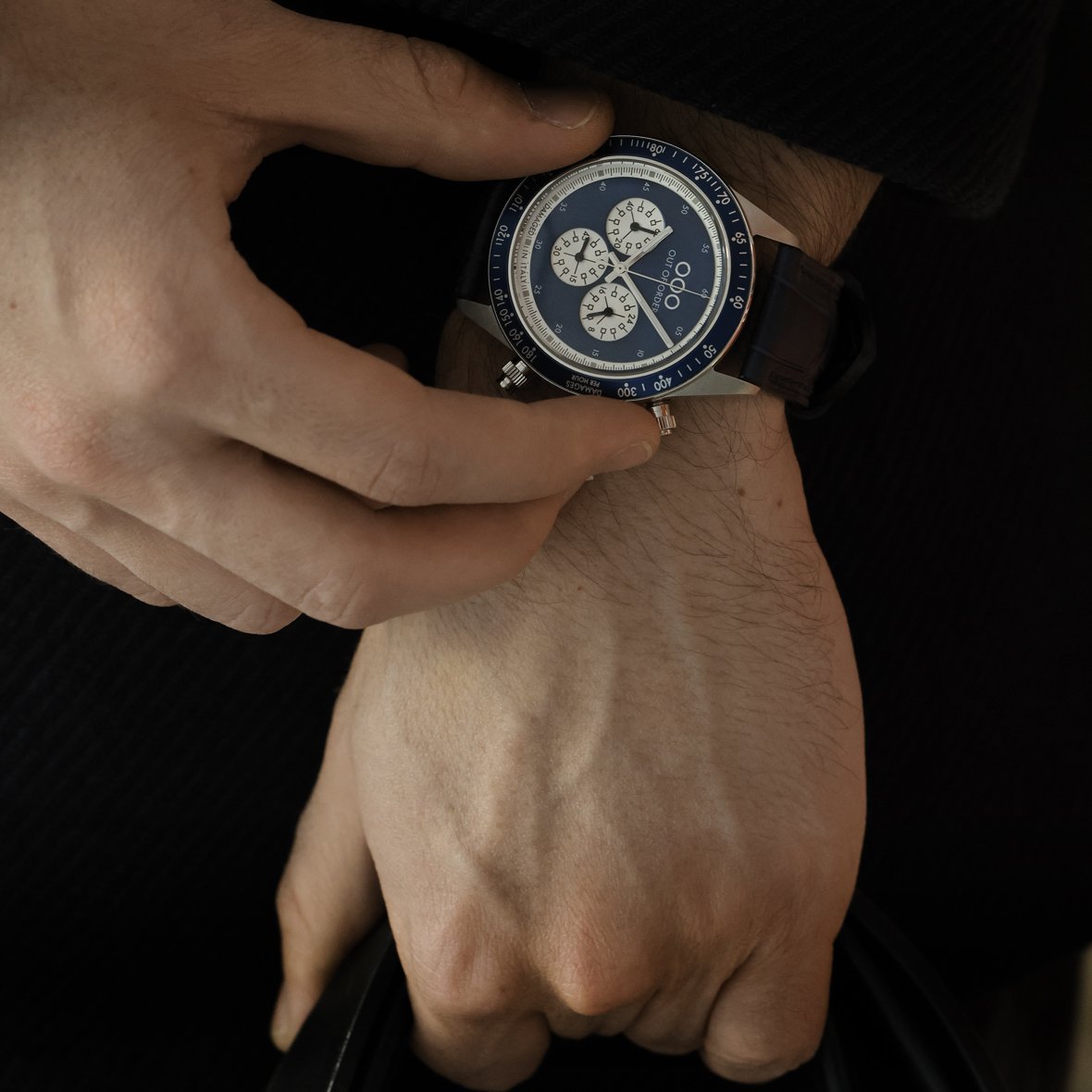 Orologio al polso con quadrante blu e cinturino in pelle blu scuro.