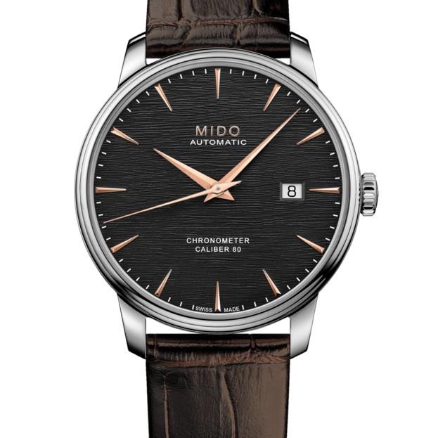 Orologio automatico con quadrante nero a righe, lancette oro rosa e datario.