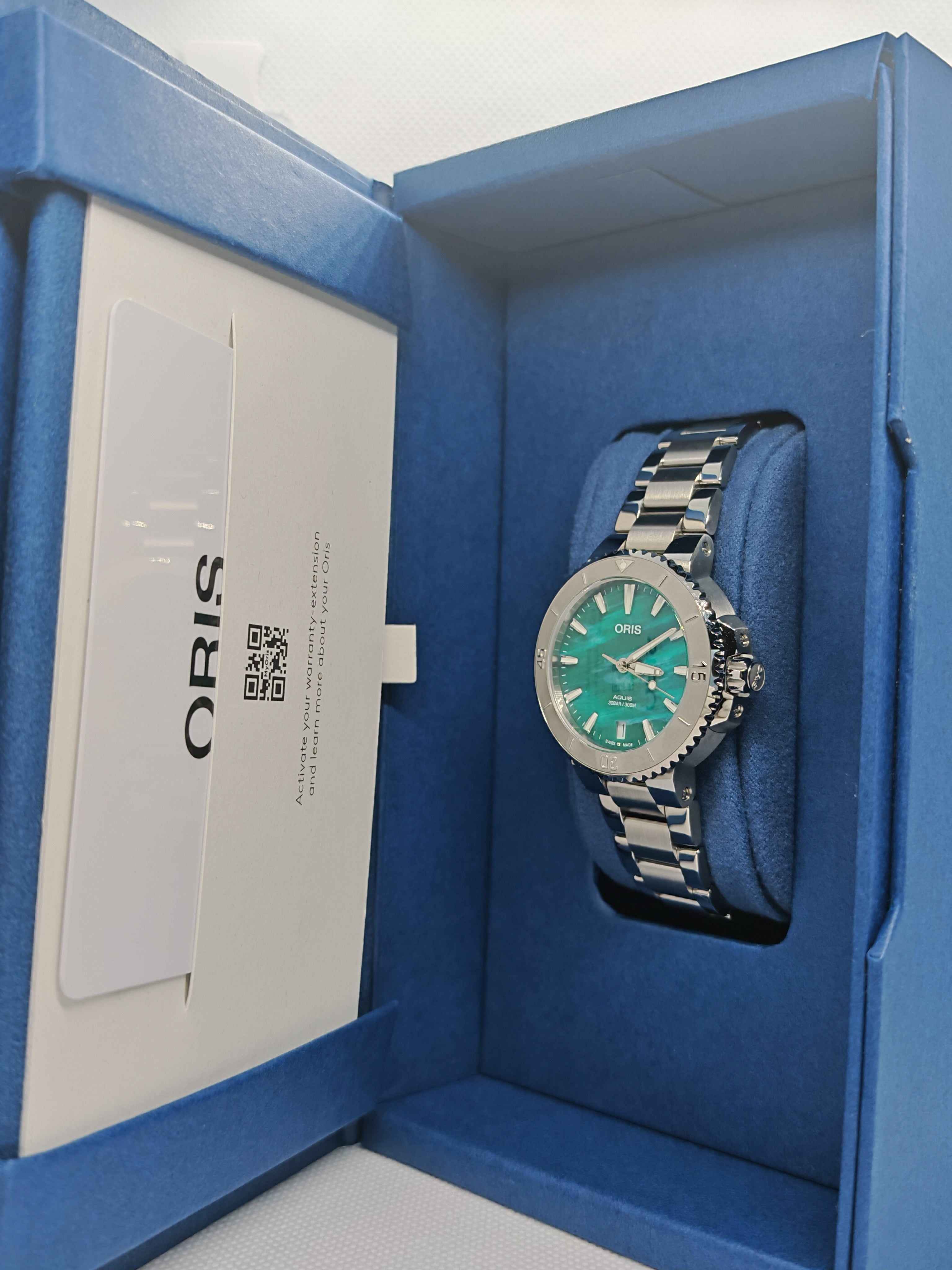 Orologio con quadrante verde e bracciale in acciaio nel cofanetto blu