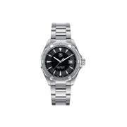 Orologio TAG Heuer Aquaracer 300M con quadrante nero, lunetta oro giallo, bracciale acciaio