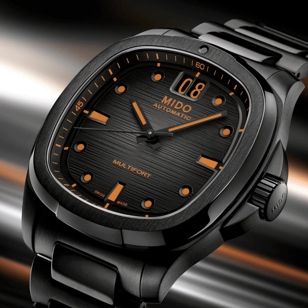 Orologio Mido automatico con quadrante nero a texture e indici arancioni, Big Date